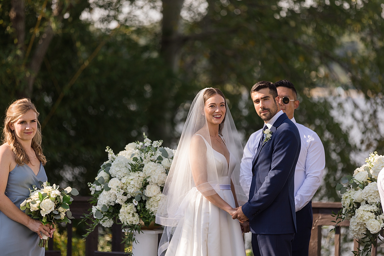 bride and groom look at guests during ceremony