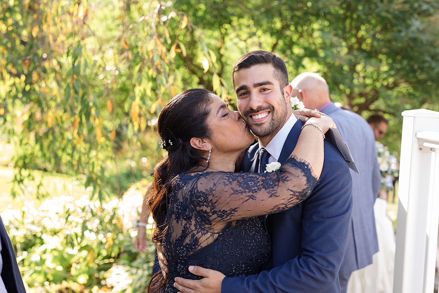 groom's mom kisses his cheek