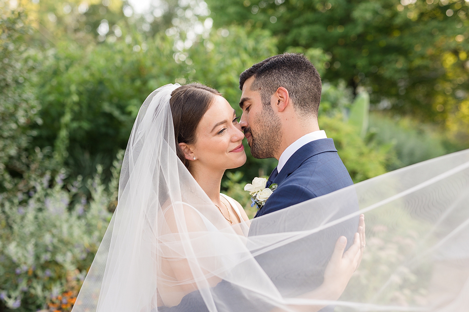 couple portrait holding veil