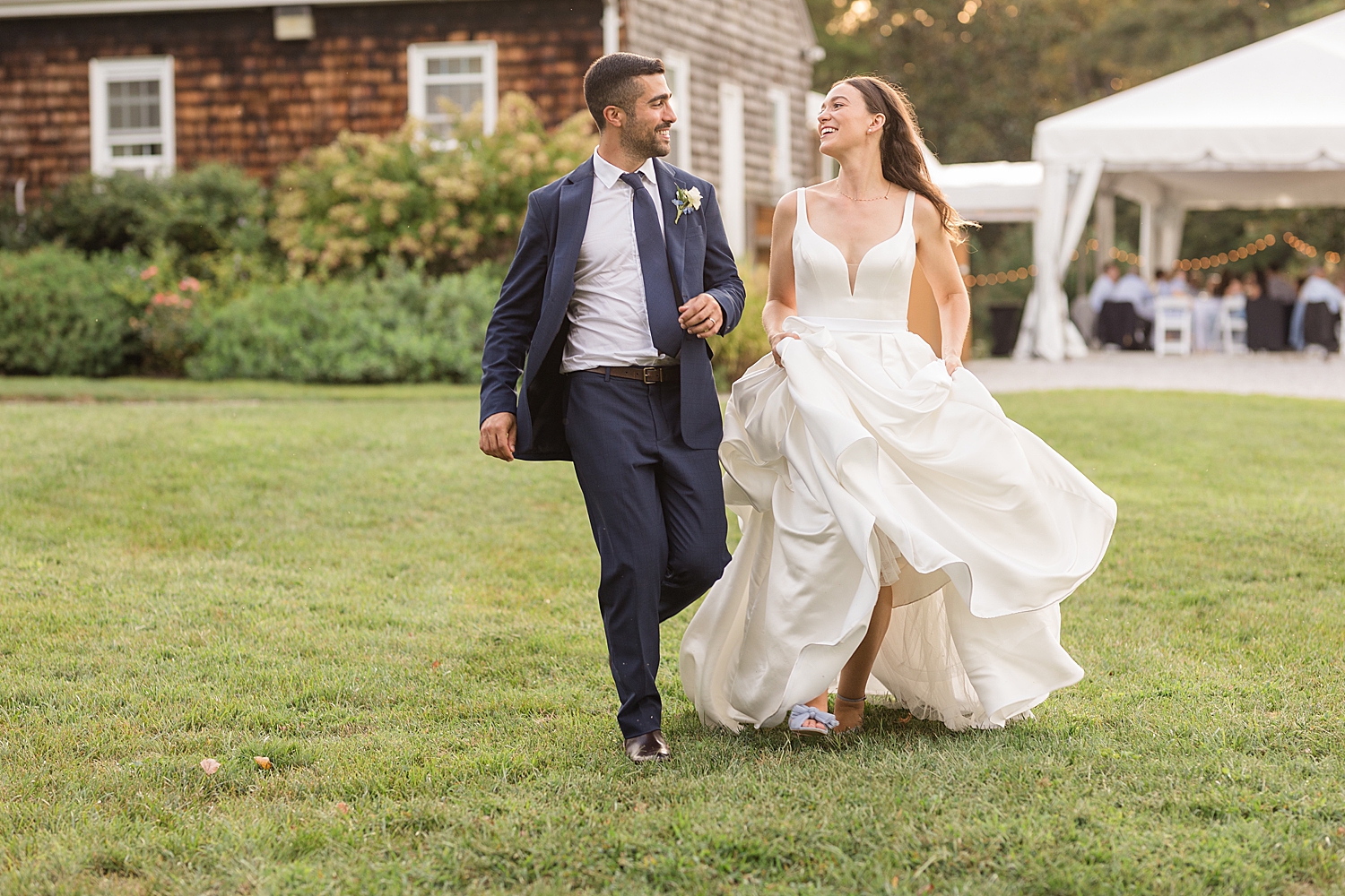 bride and groom walking laughing