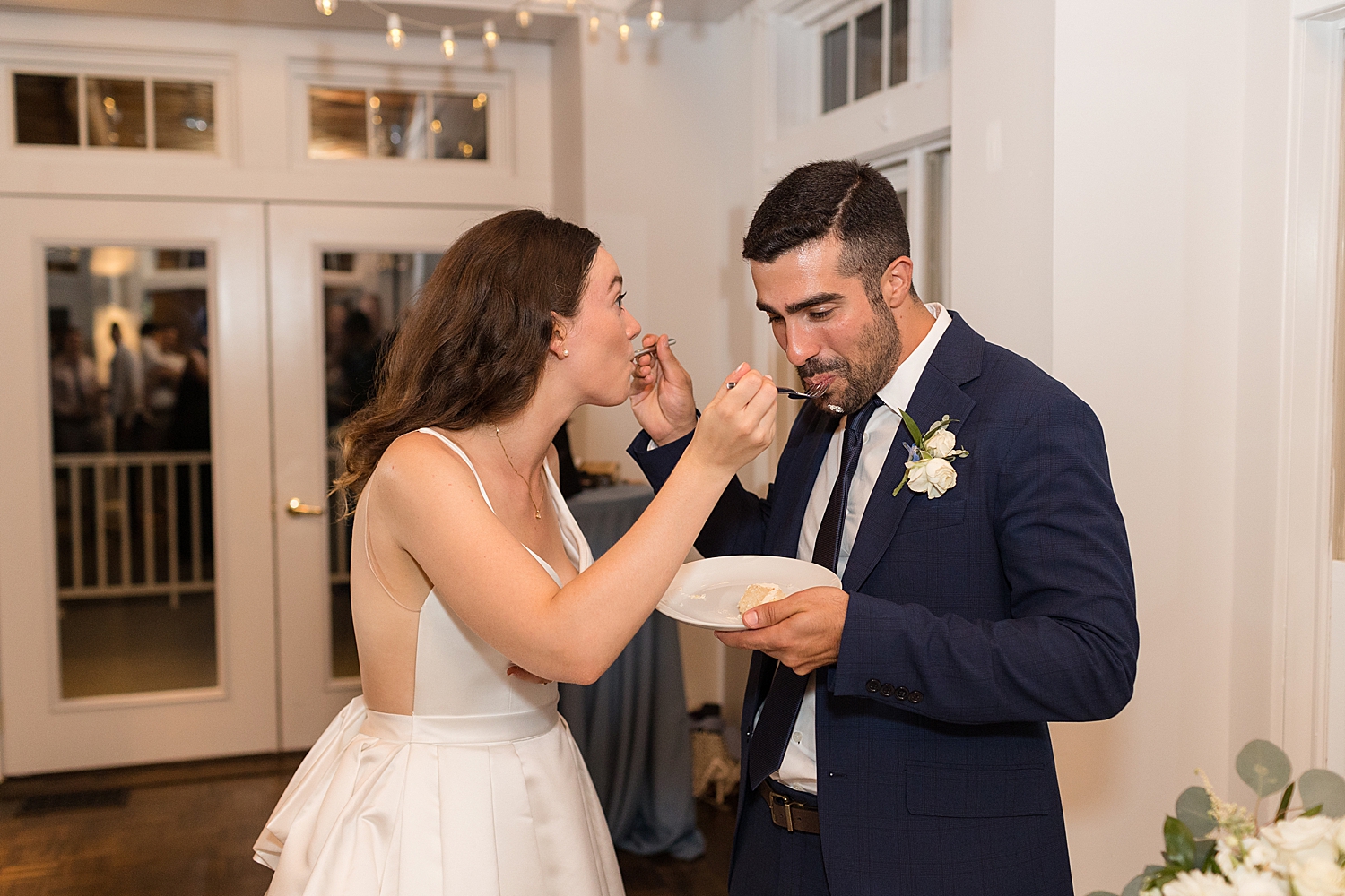 cake cutting couple feeding each other