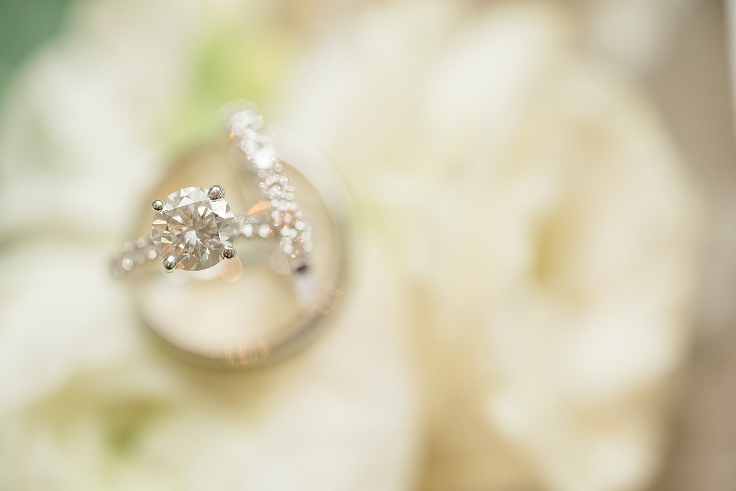 rings in focus on top of white florals