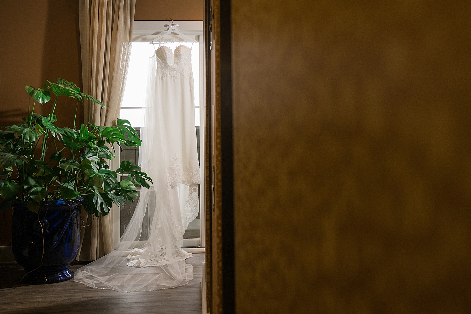 wide shot bridal dress hanging