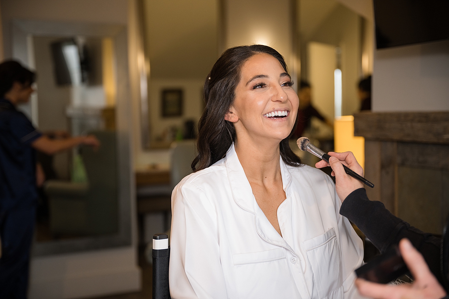 bride getting ready in makeup chair