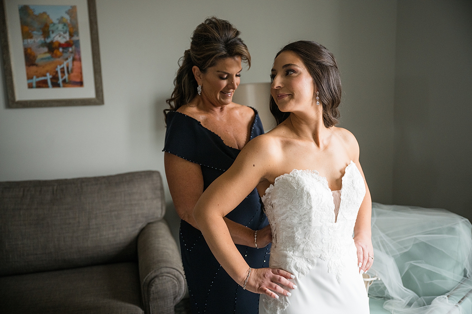 bride getting dressed with mom