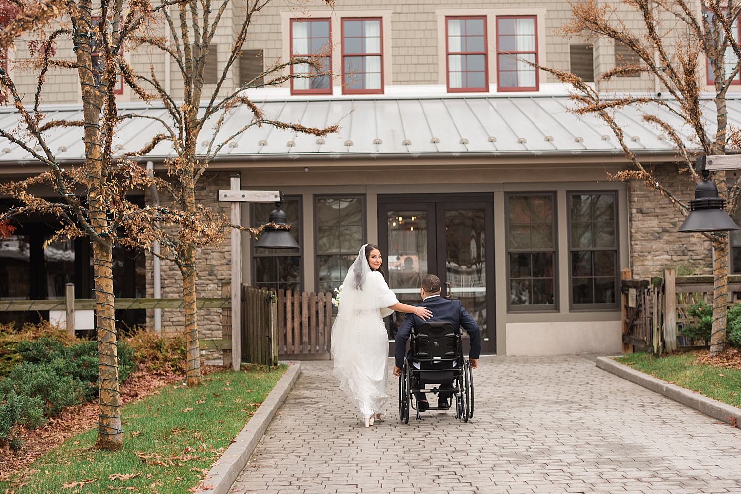 bride peeks over shoulder walking away with groom