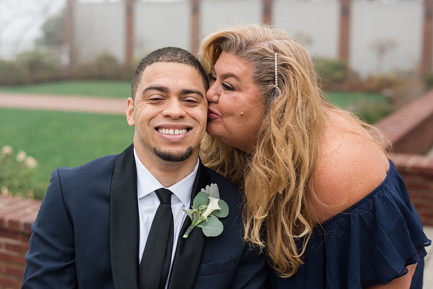 groom's mom kisses his cheek