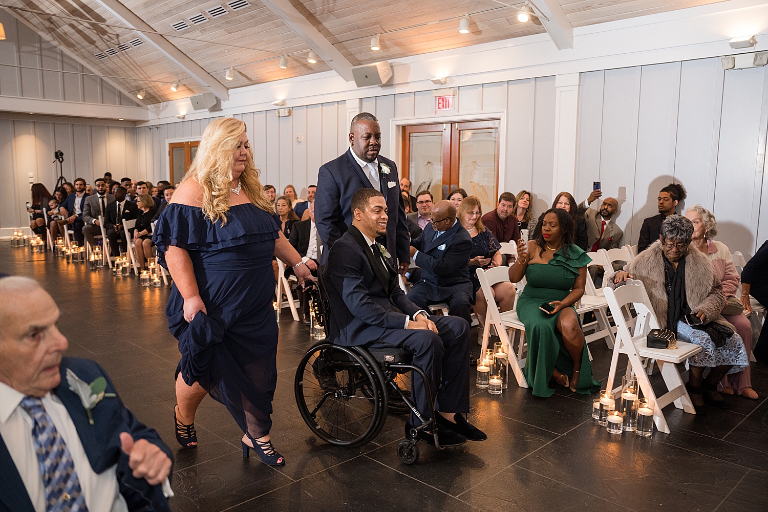 groom in wheelchair entering ceremony with parents