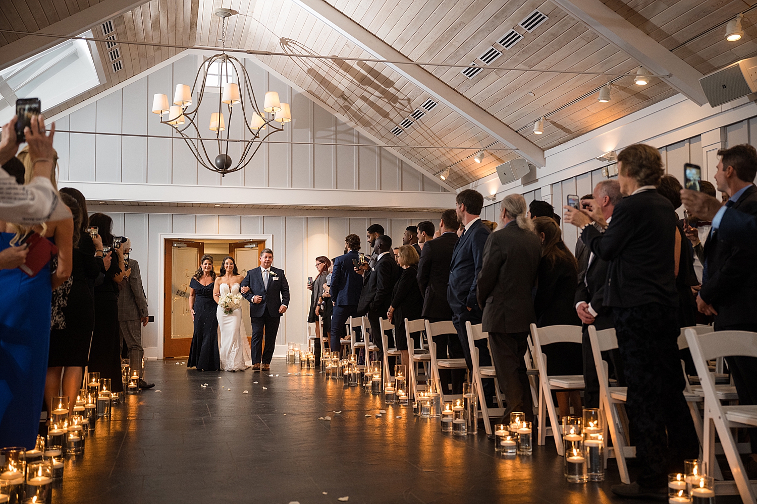 bride walking down the aisle with her parents