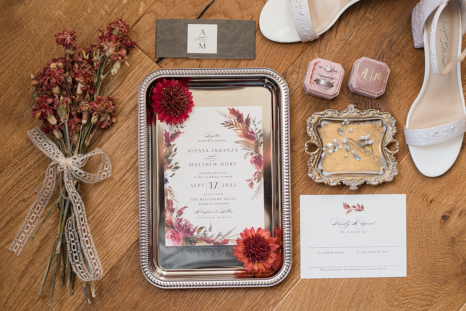 flat lay wedding details invitation suite red accents