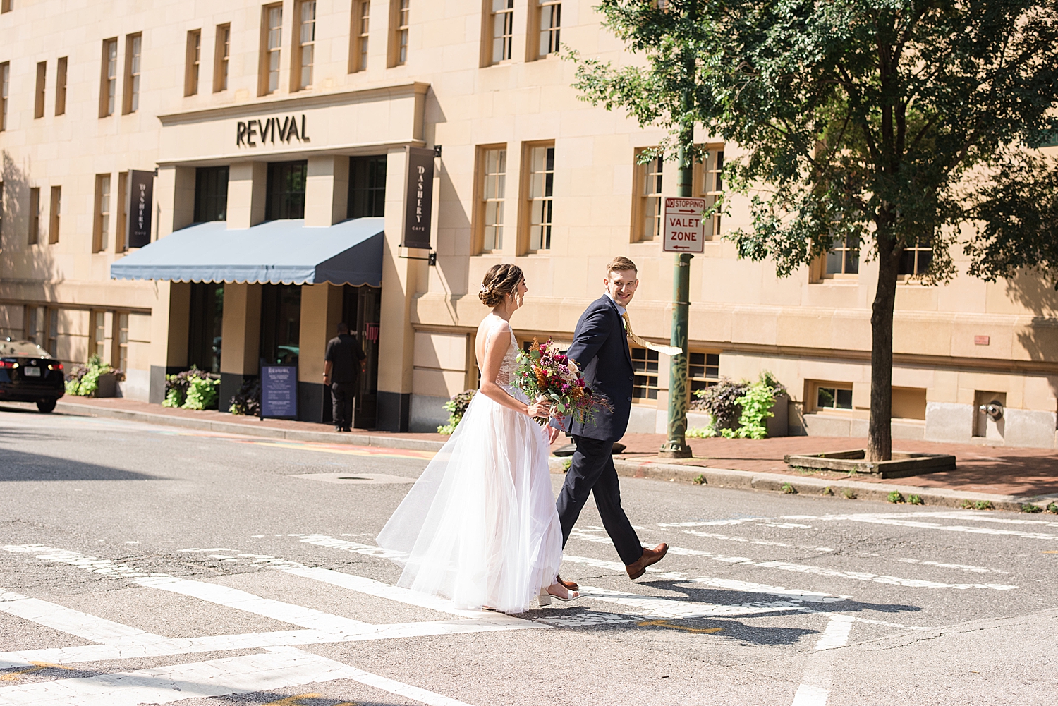 bride and groom walking across the street