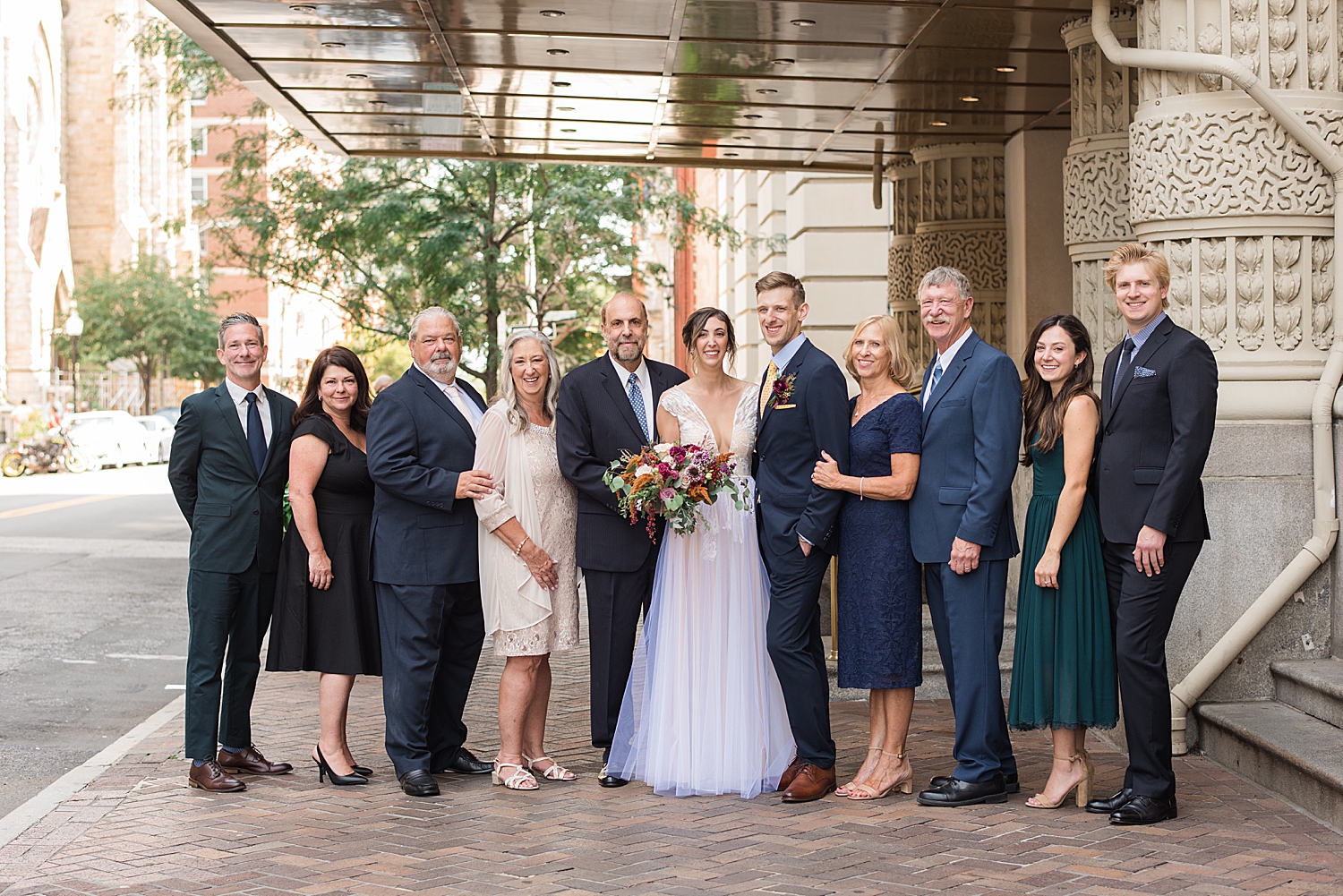 bride and groom with family members formal