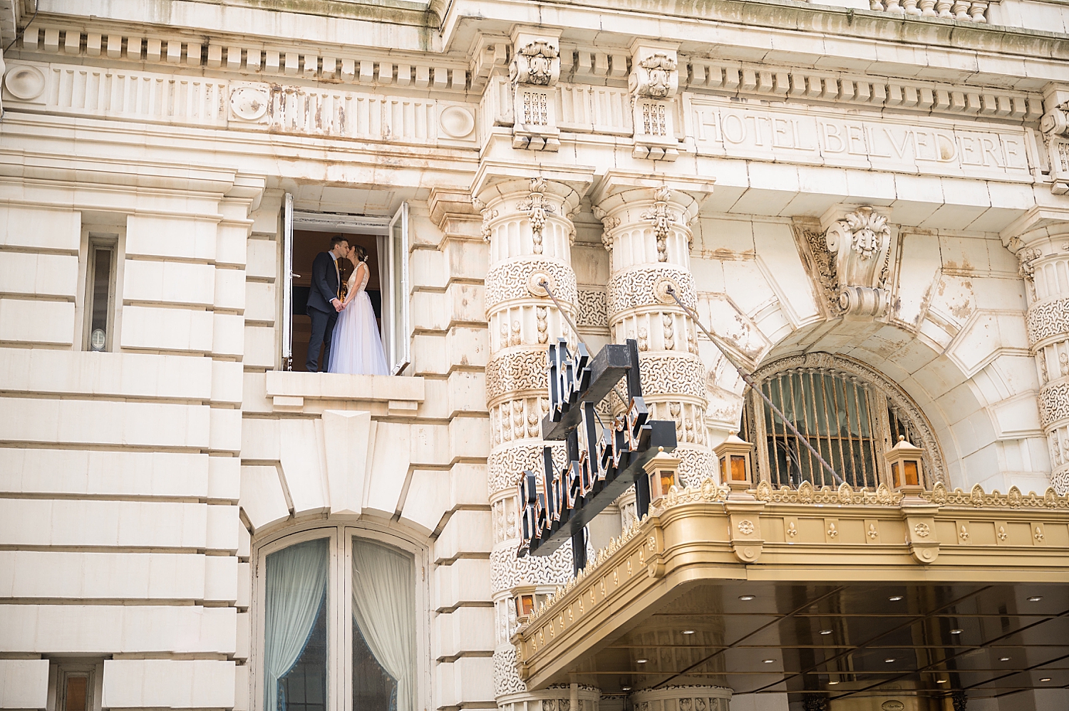 bride and groom in window at belvedere hotel baltimore