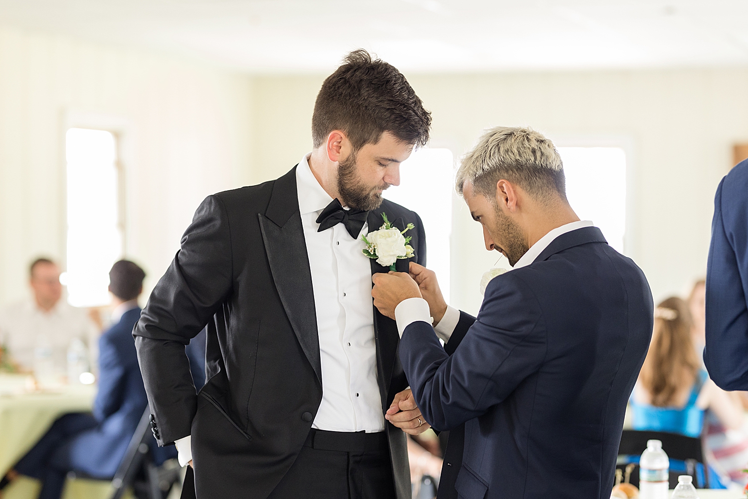 groom getting ready boutonniere pin