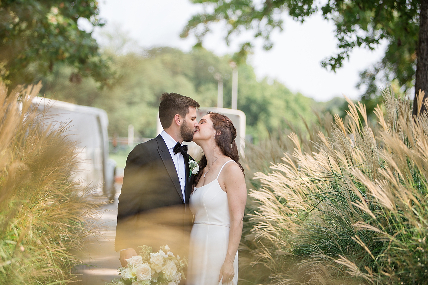 bride and groom portrait kiss reeds