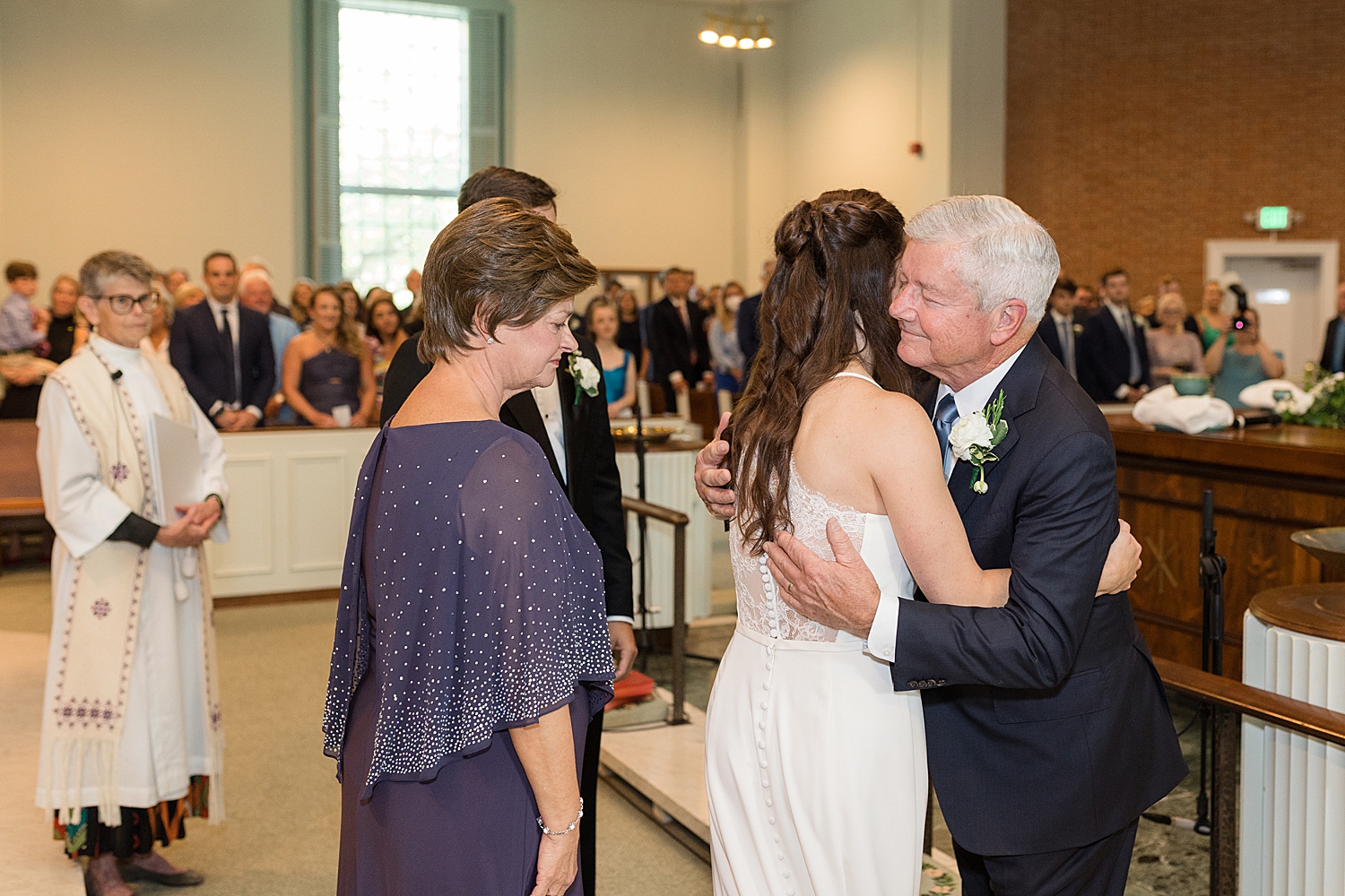 bride enters ceremony hugs dad