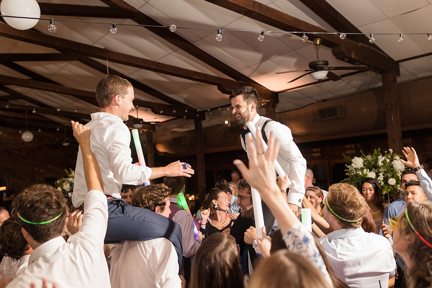 candid guests dancing hora chairs