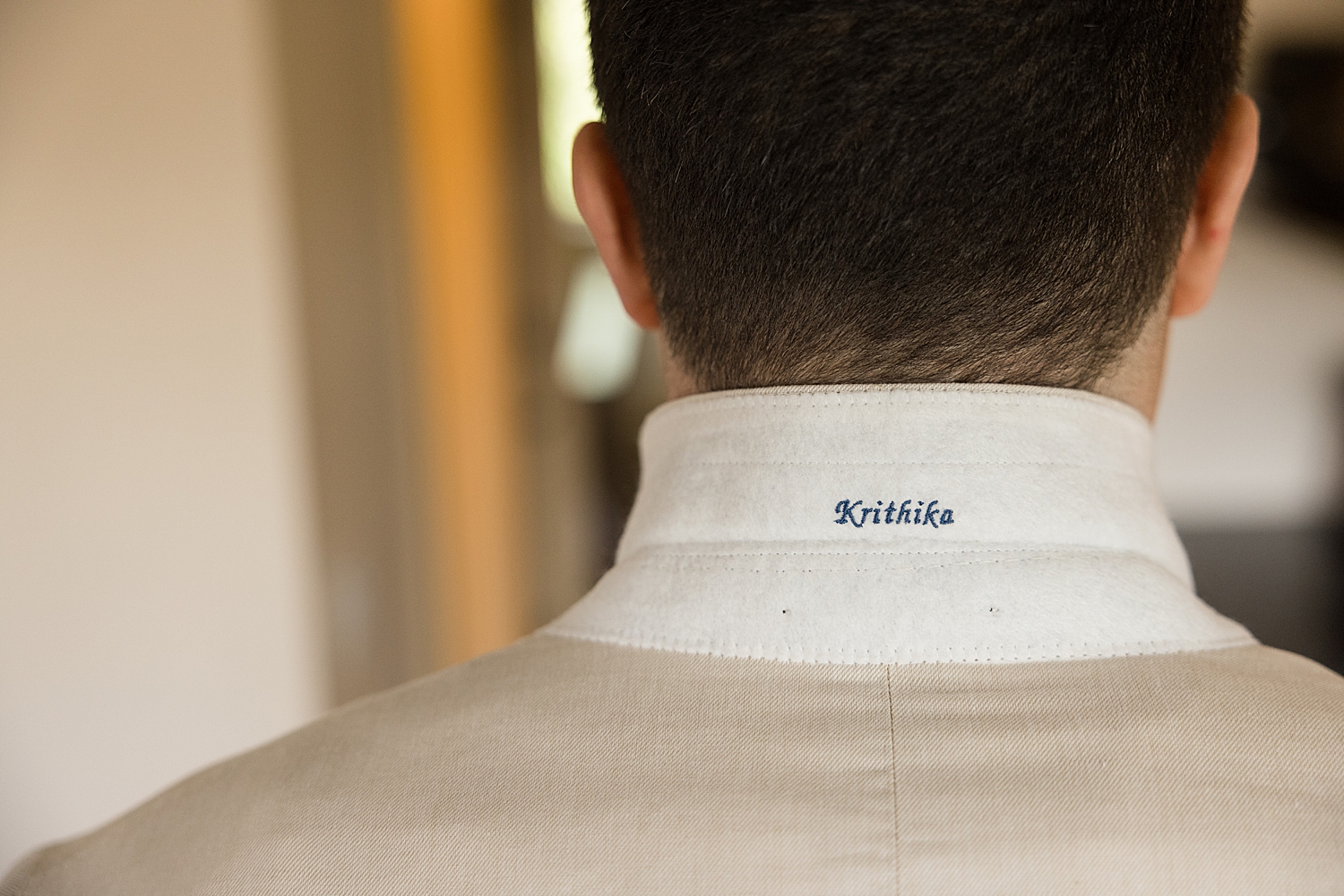 groom's suit detail bride's name under collar