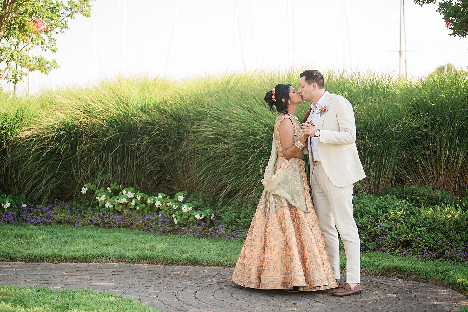 bride and groom kiss garden