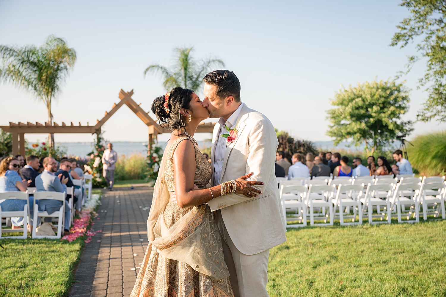 bride and groom kiss at end of aisle after ceremony