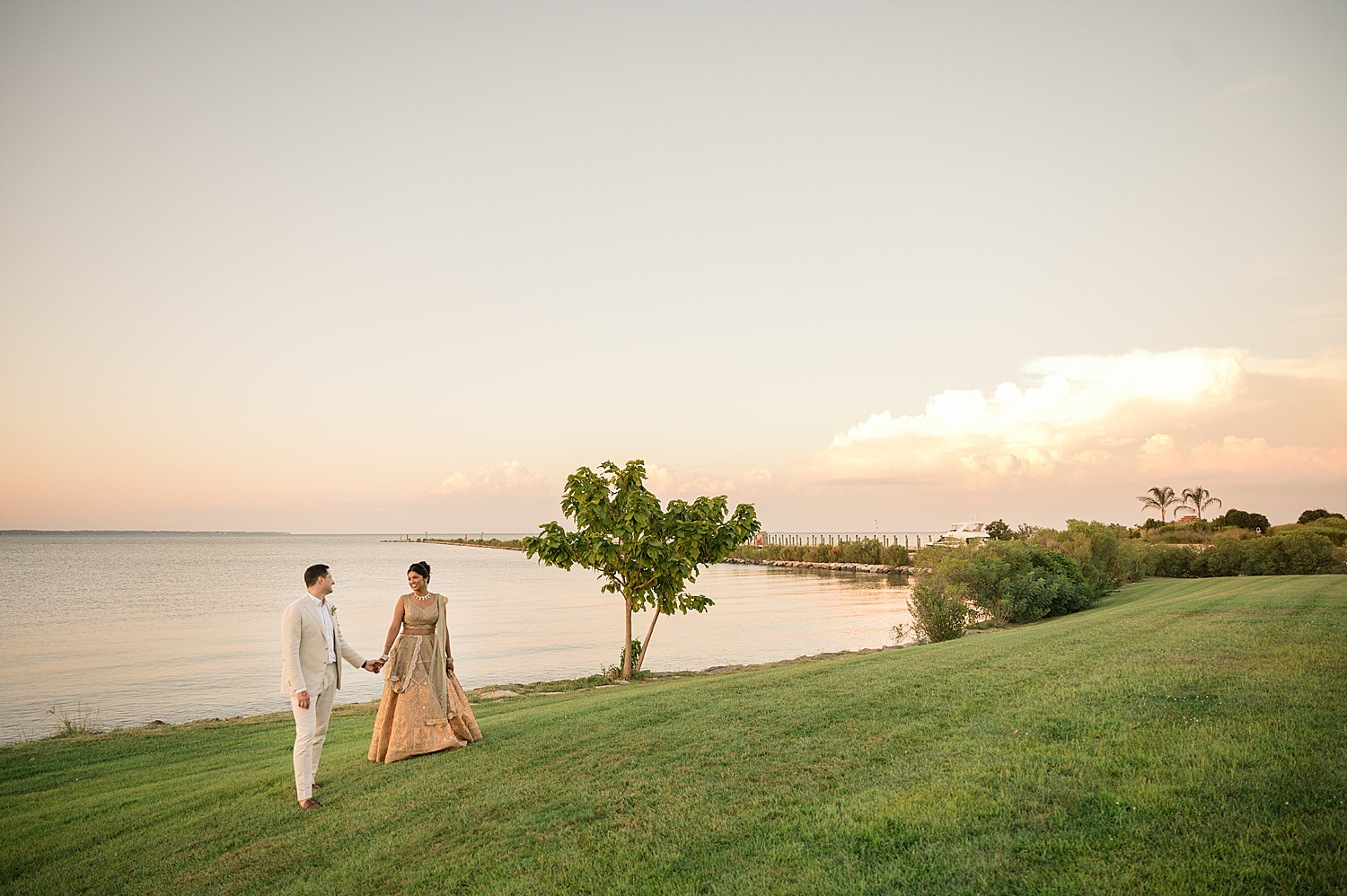 bride and groom portrait walking across polynesian lawn