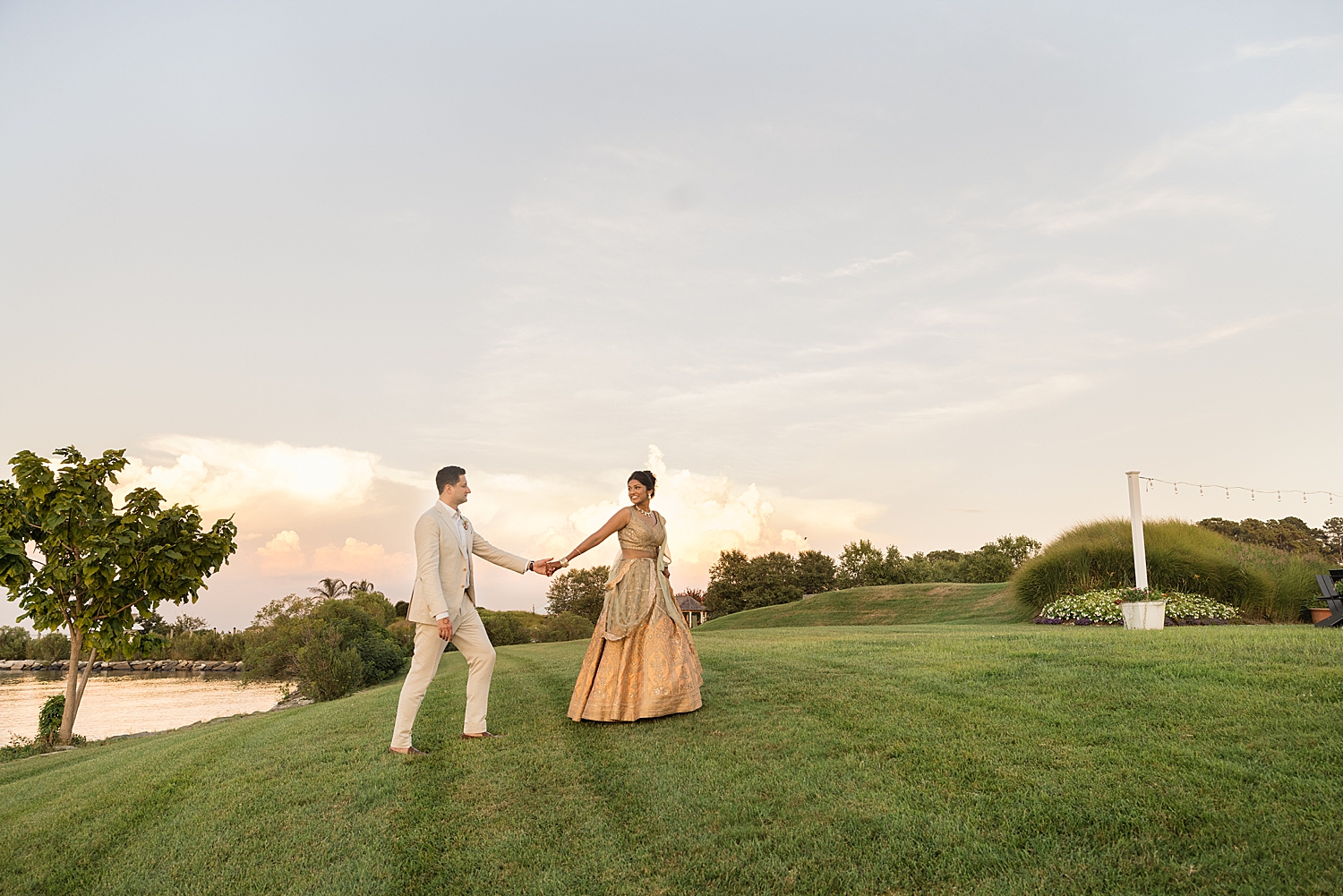 bride and groom portrait walking across polynesian lawn