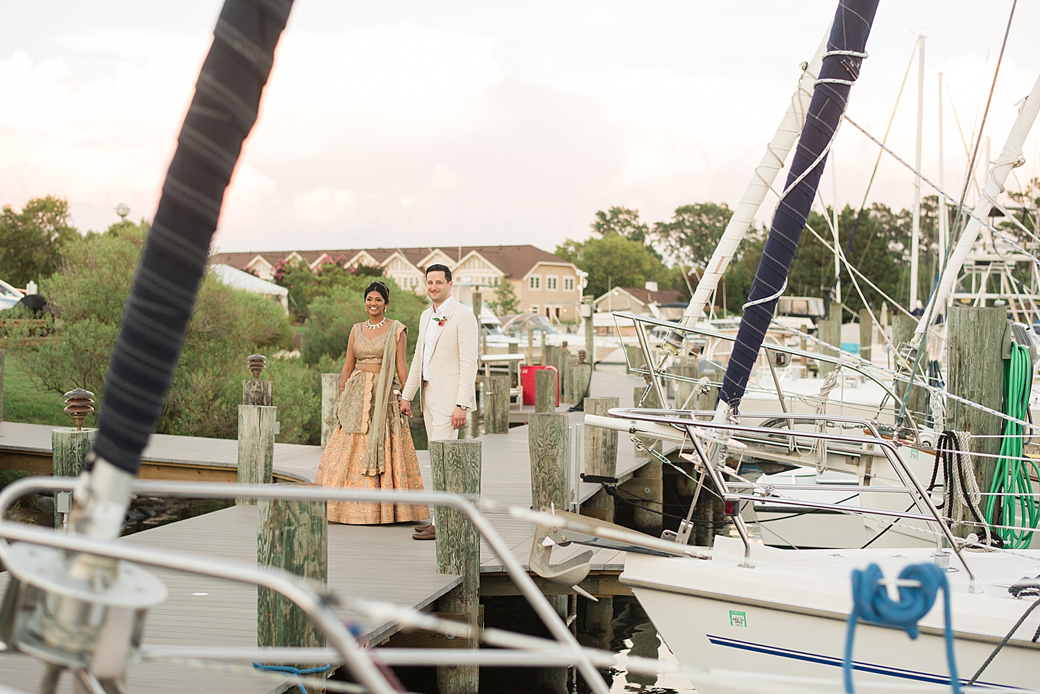 bride and groom walk through harbor