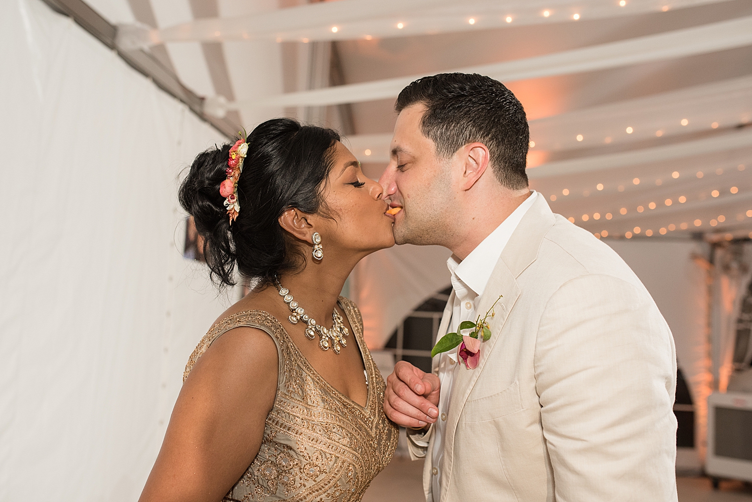 bride and groom kiss after cake cutting