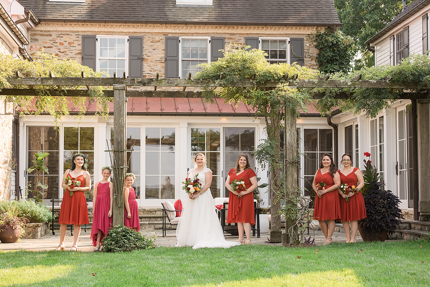 bride styled with bridesmaids and flower girls