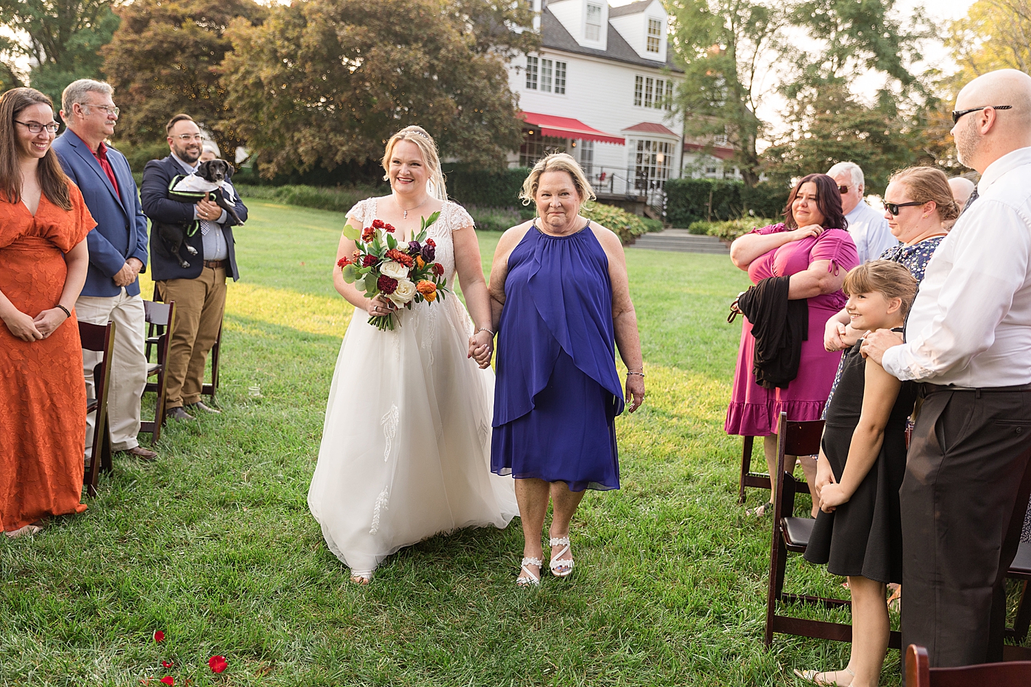 bride walking down aisle with mom