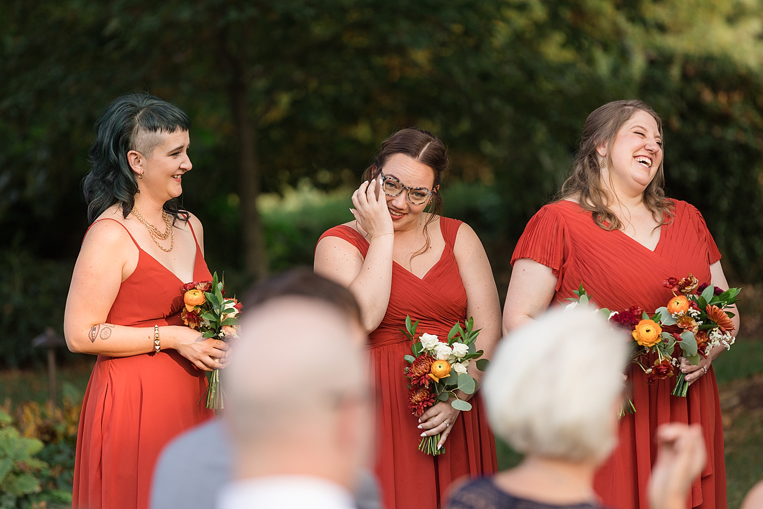 bridesmaids wiping tears during ceremony