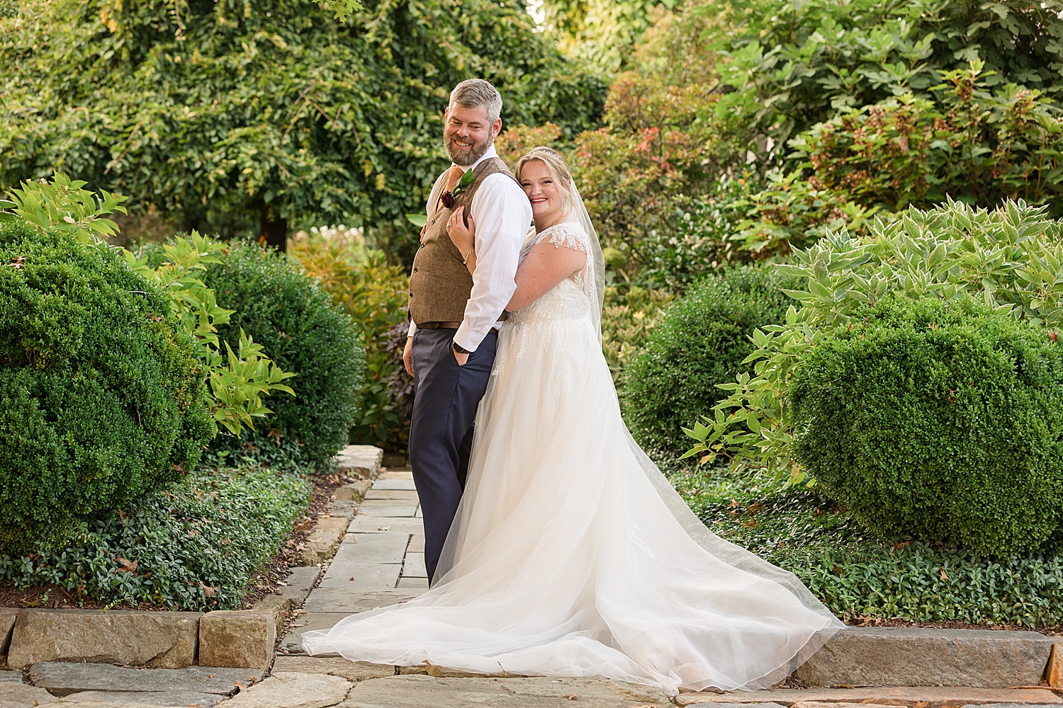 bride embraces groom from behind