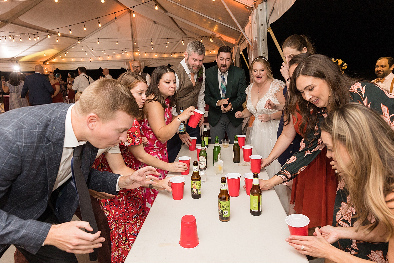 candid guests flip cup drinking game wedding party