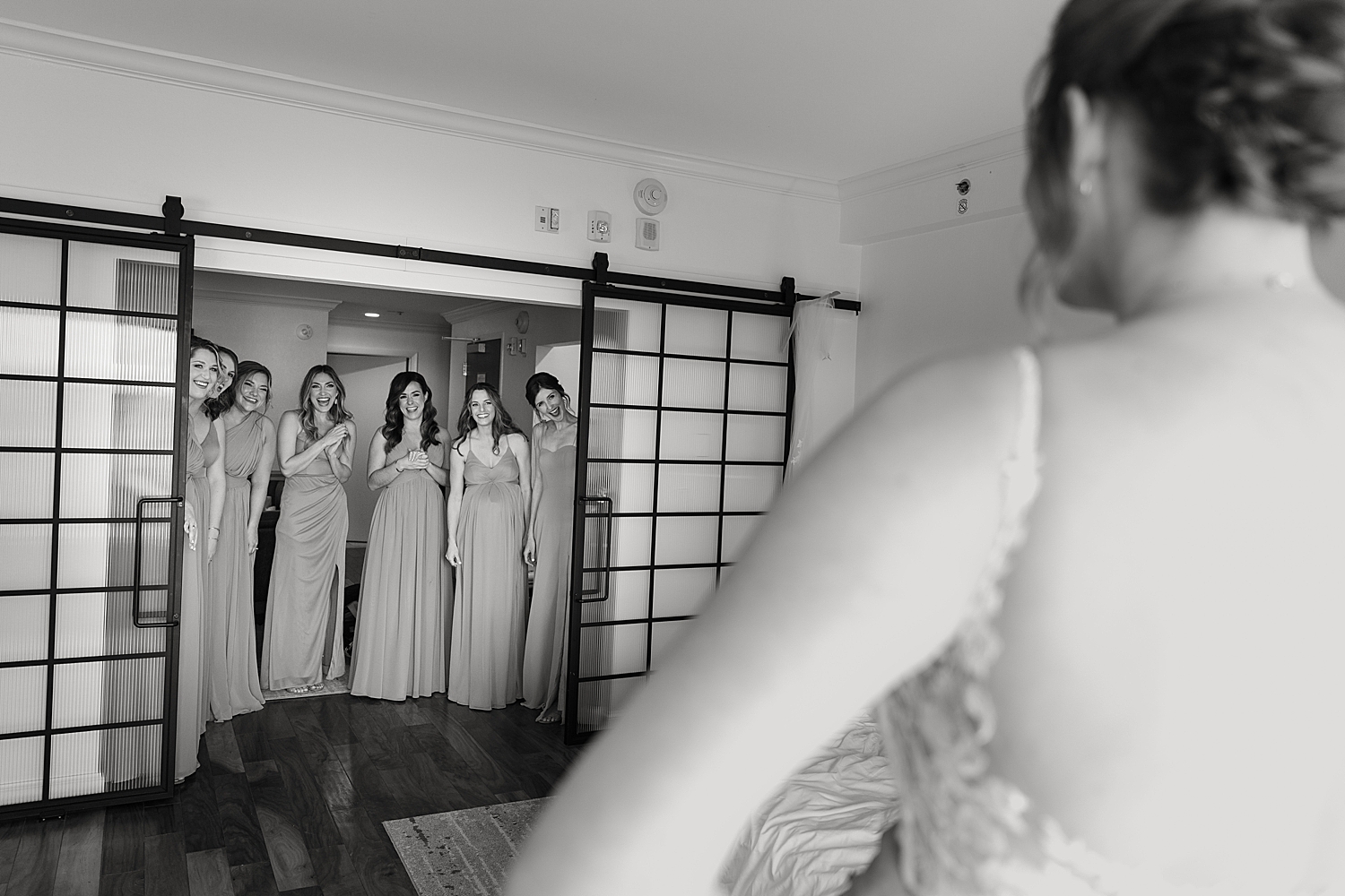 bride reveals gown to bridesmaids