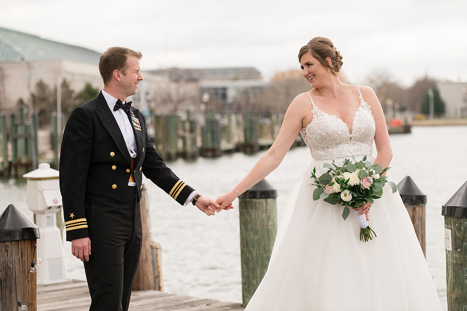 bride and groom walking on annapolis dock