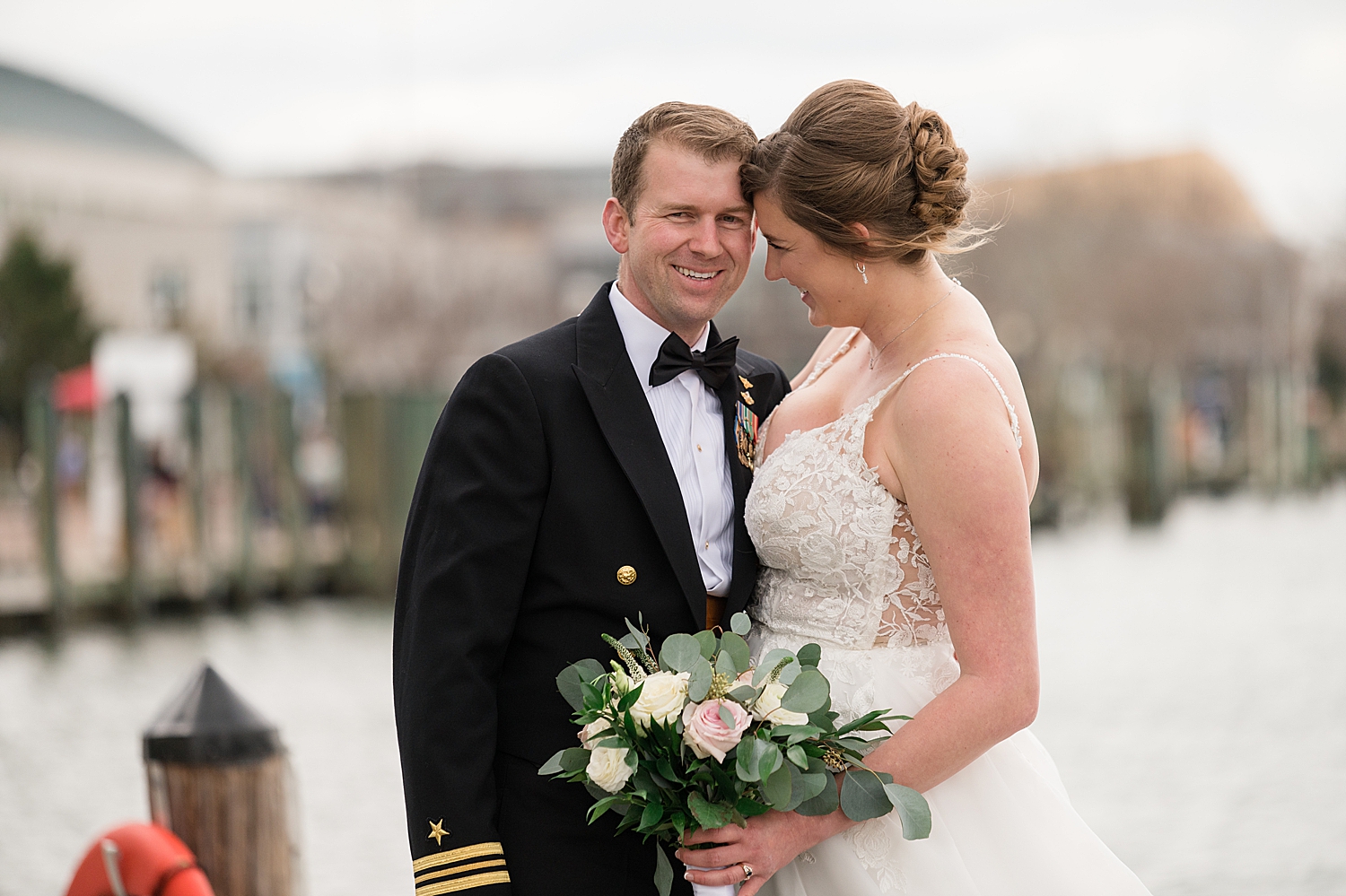 bride and groom walking on annapolis dock