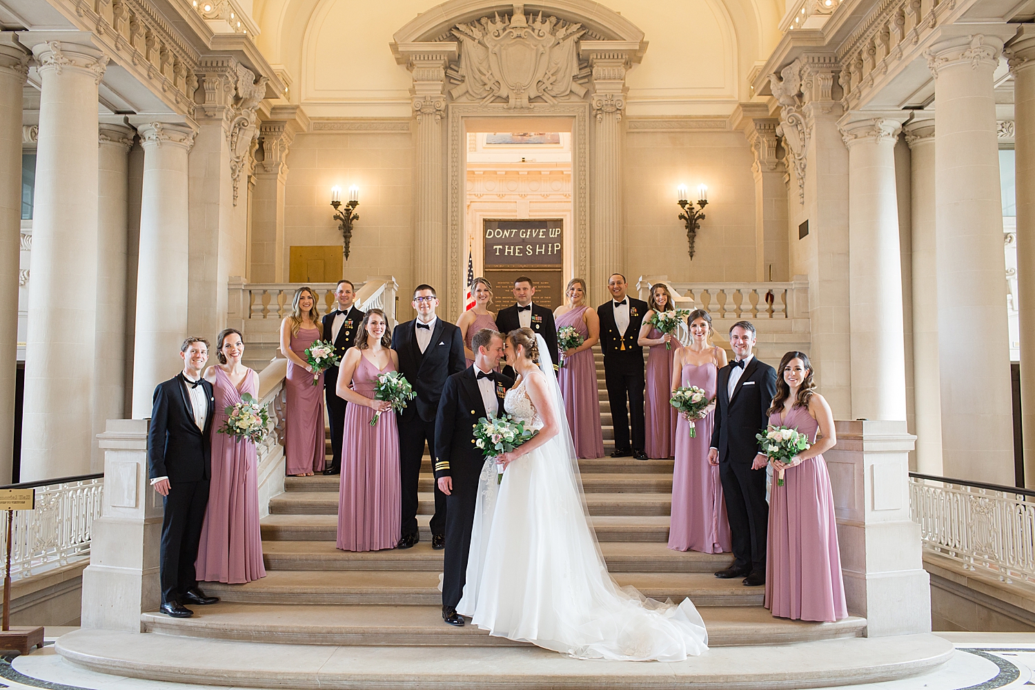 full wedding party on bancroft hall stairs indoor