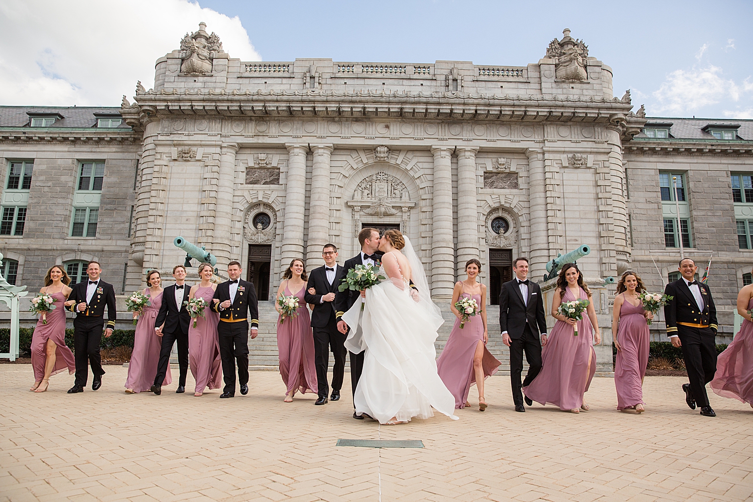 full wedding party in front of bancroft hall annapolis