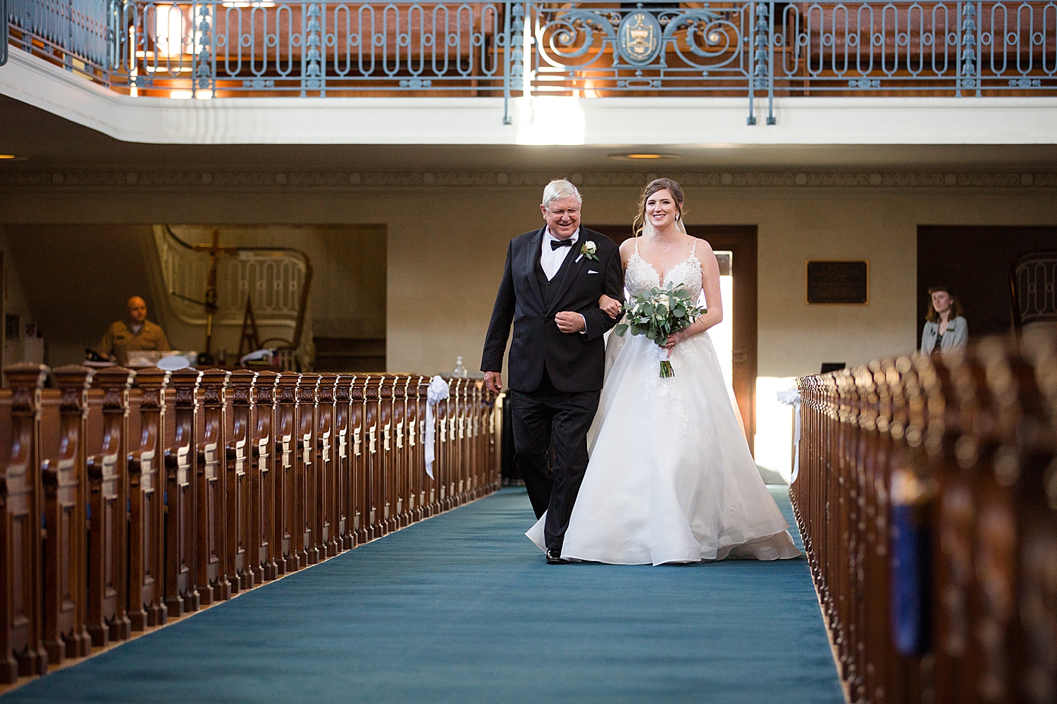 bride walking down chapel aisle with dad