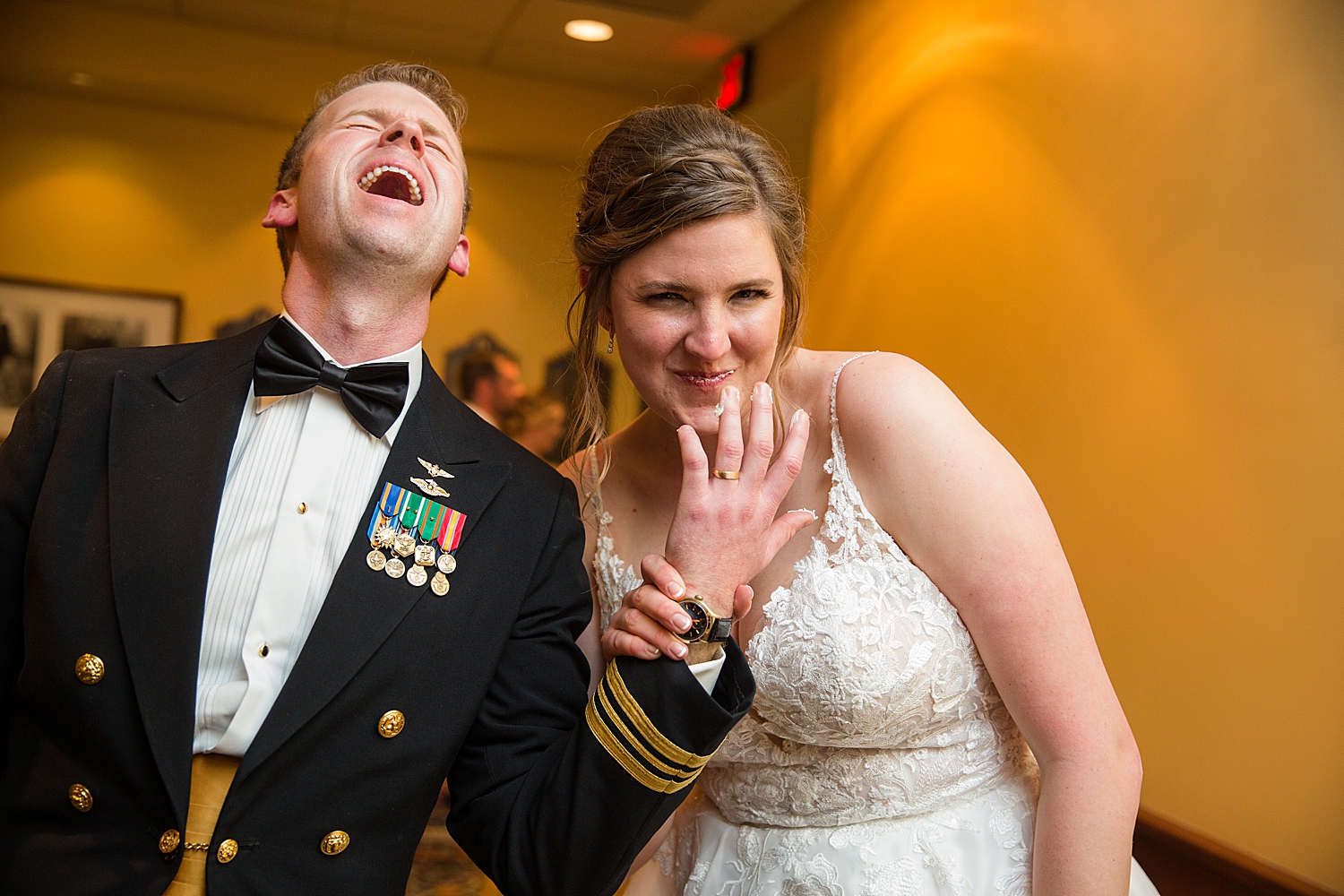 bride and groom laugh after cake cutting