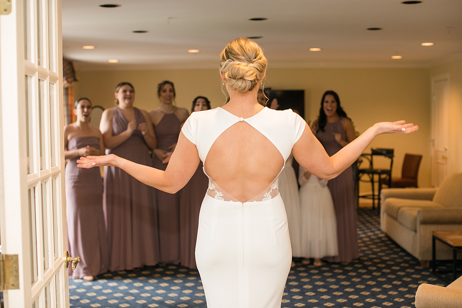 bride reveals dress to bridesmaids