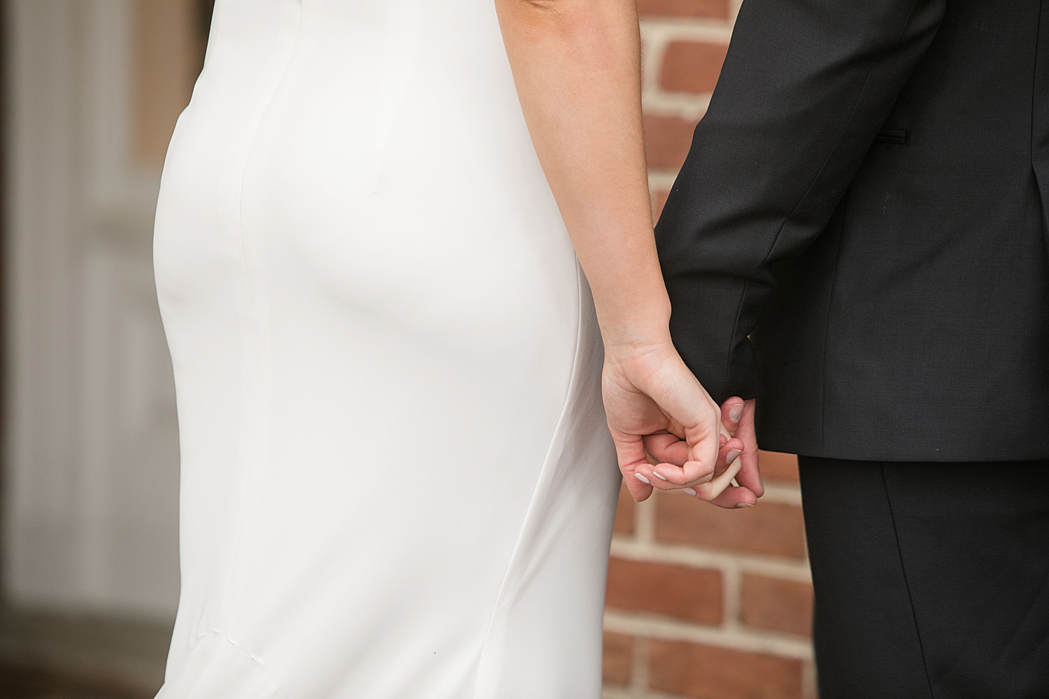 bride and groom holding hands