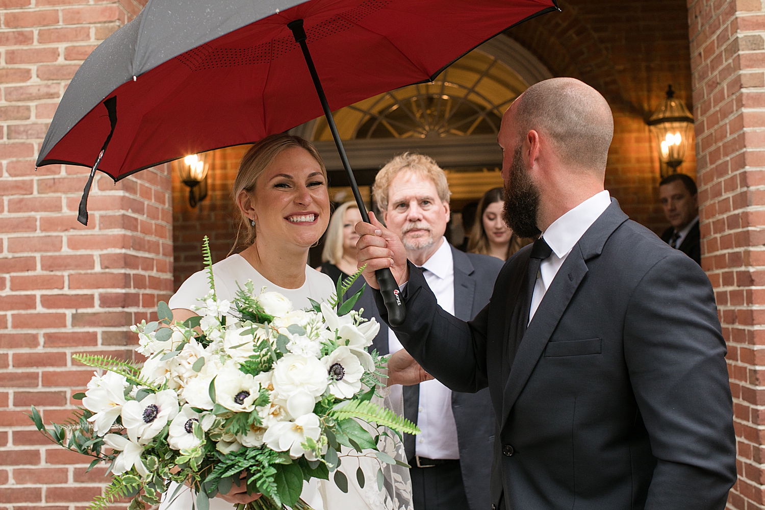 bride and groom under umbrella