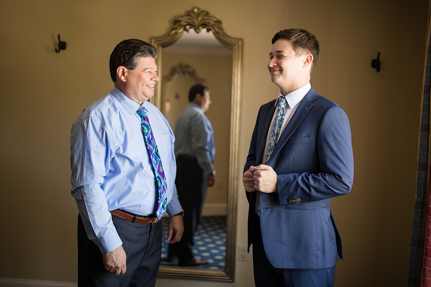 groom getting ready with dad