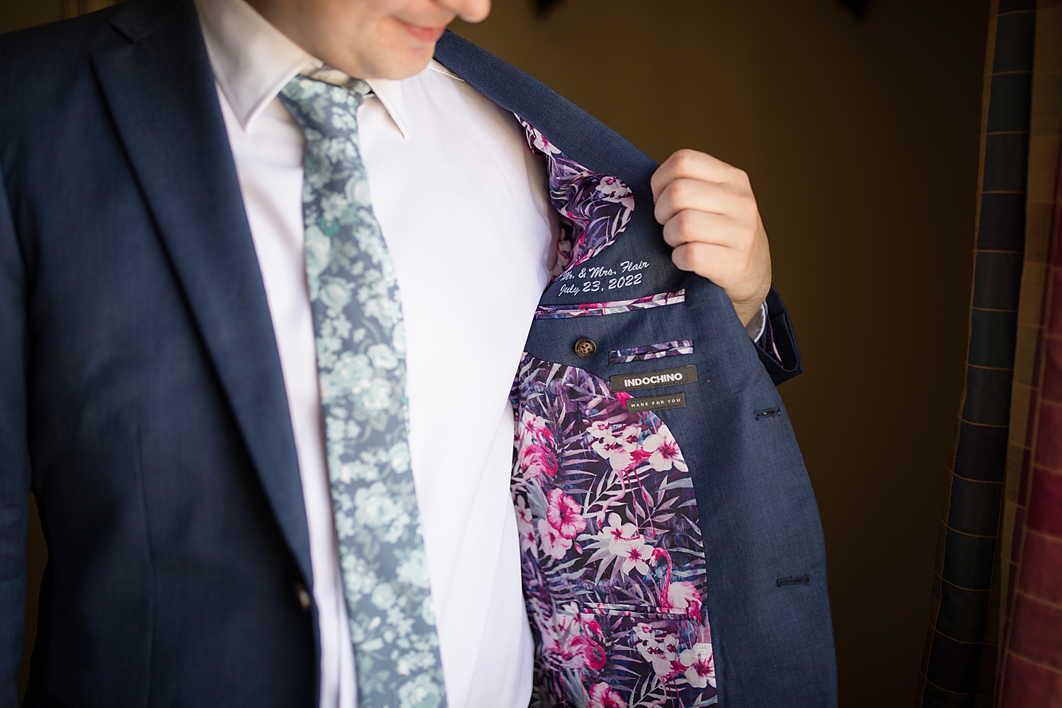 groom showing off cutstom suit lining