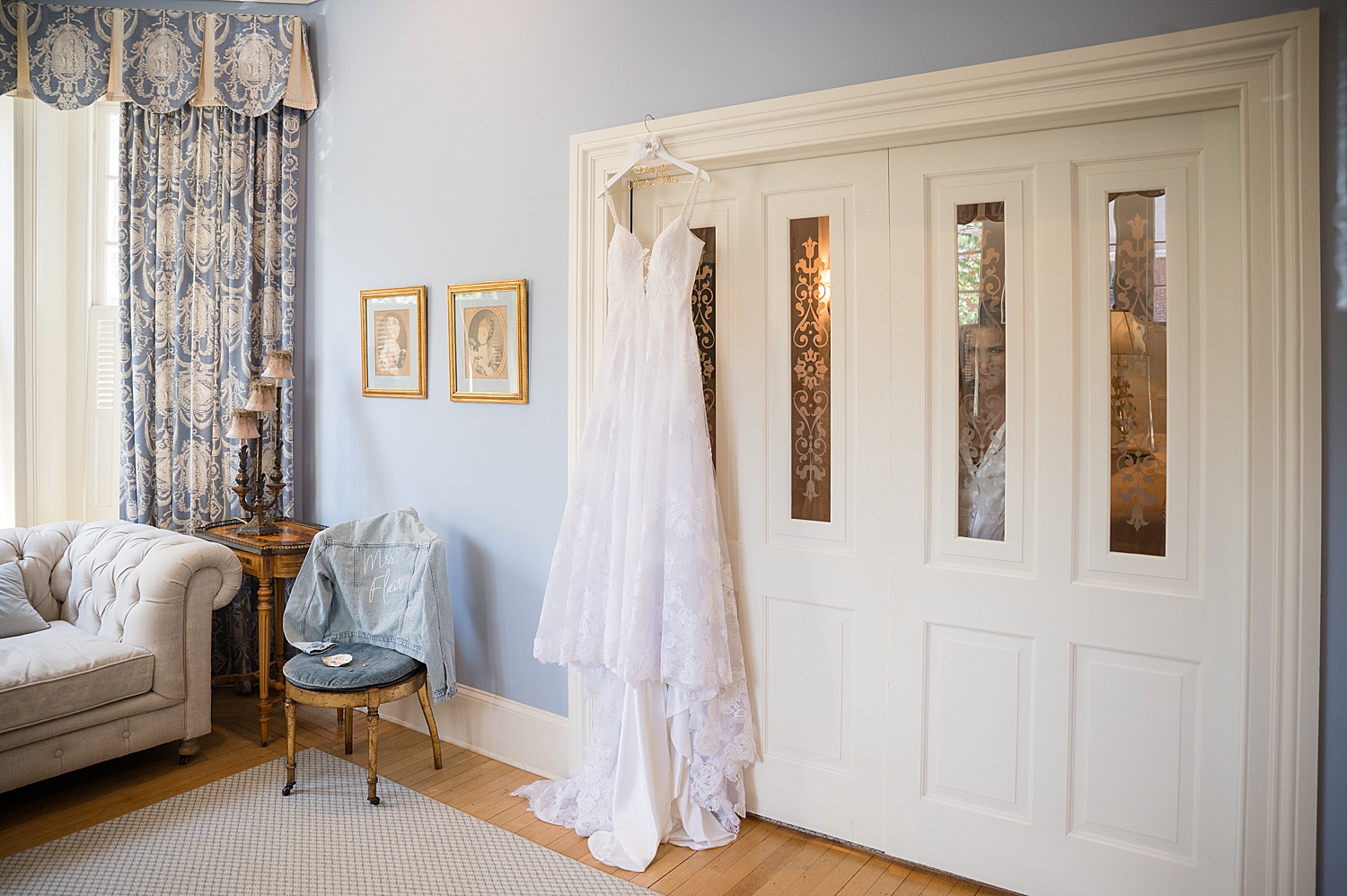 bridal gown hangs from door frame