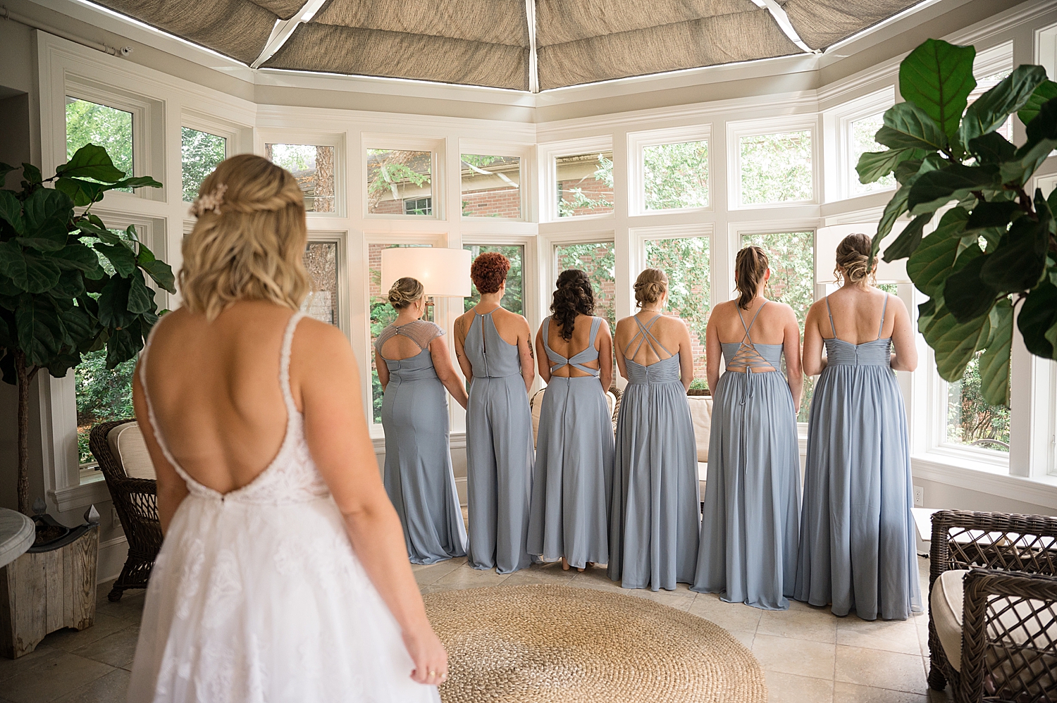 bride revealing gown to bridesmaids