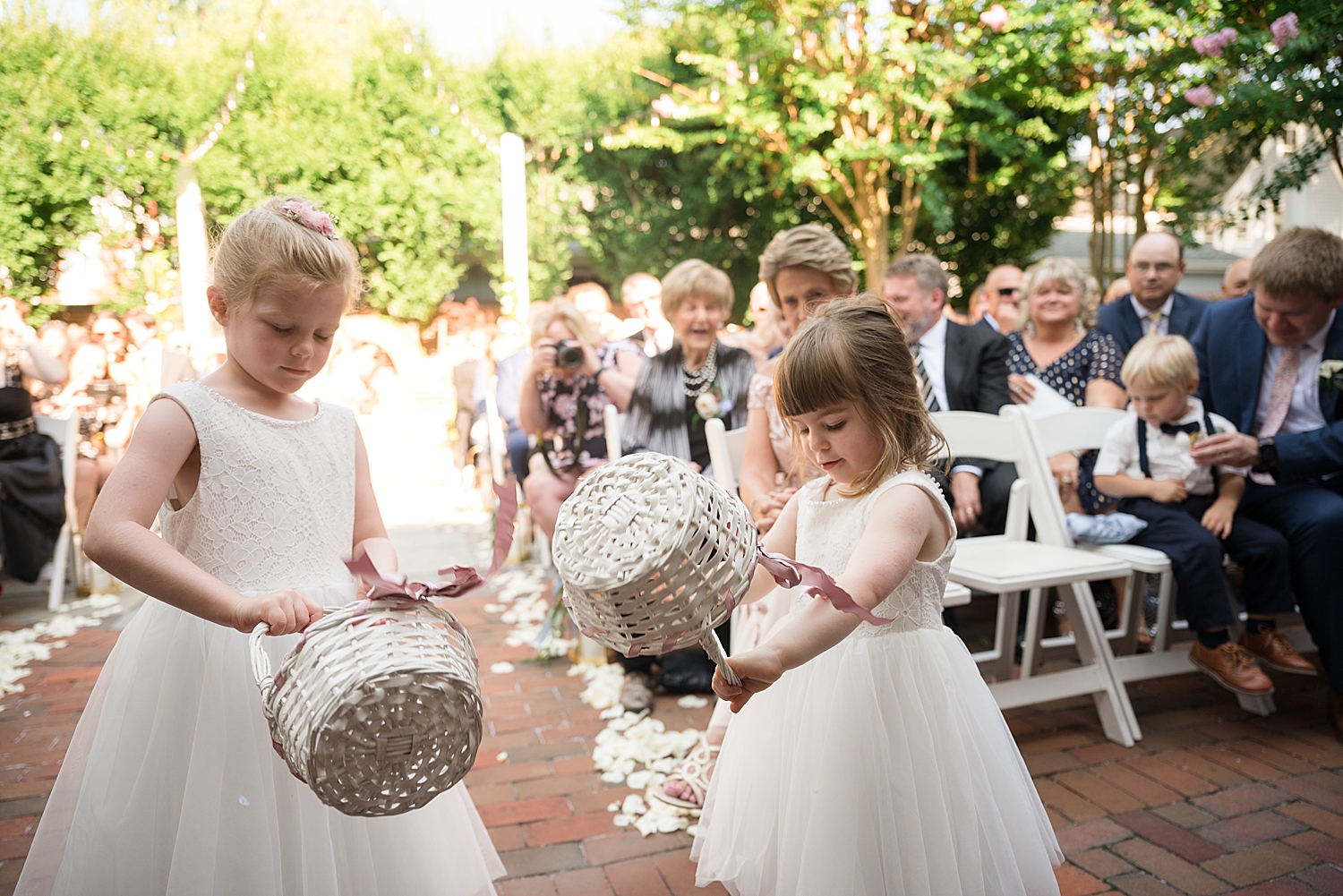 flower girls dump their baskets of petals at the end of the aisle