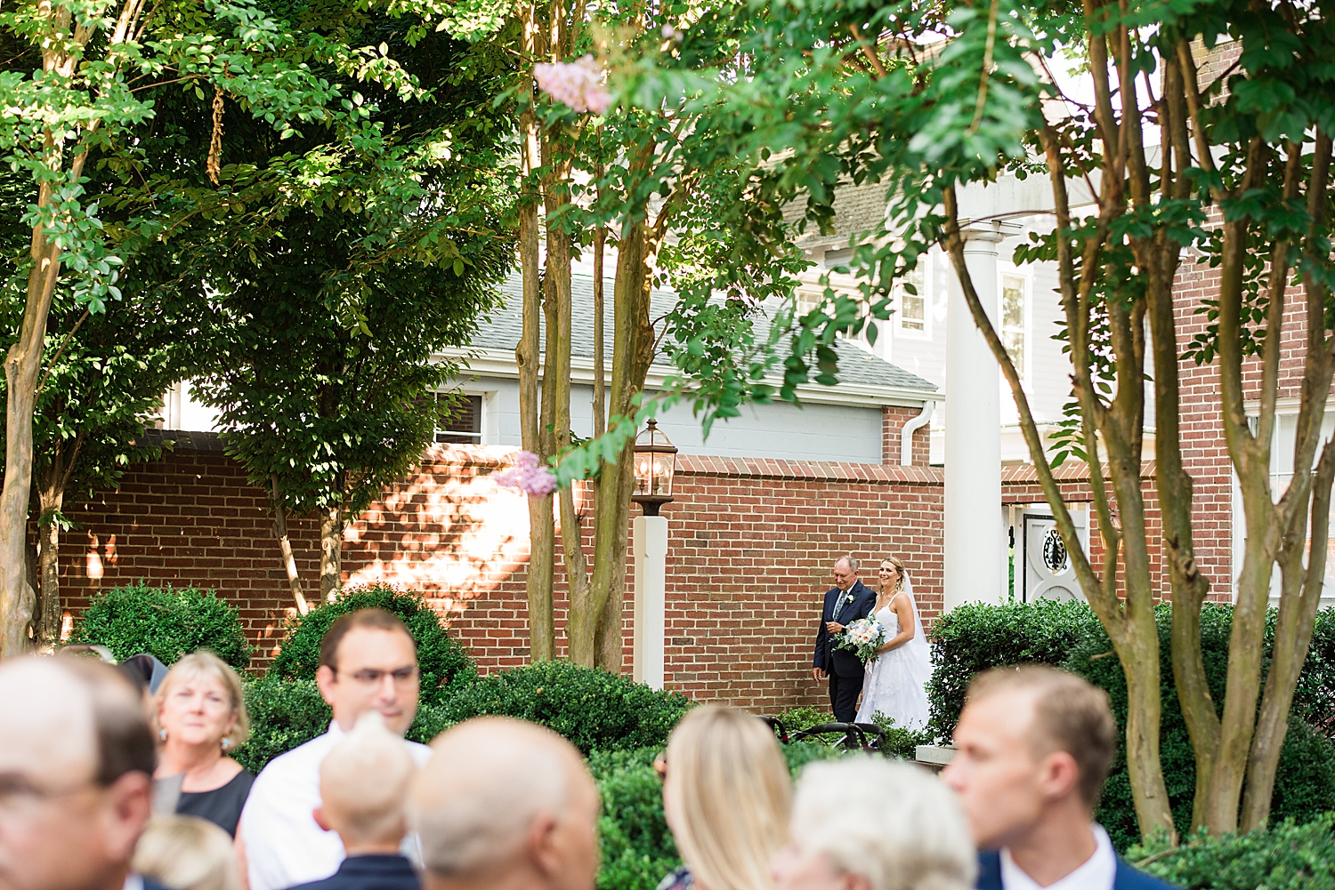 bride enters ceremony with her father