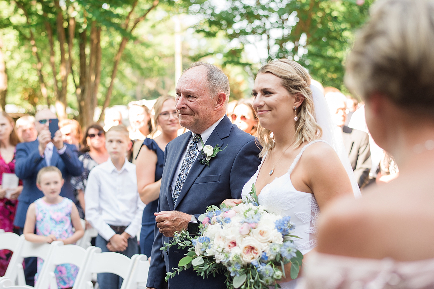 bride enters ceremony with her father